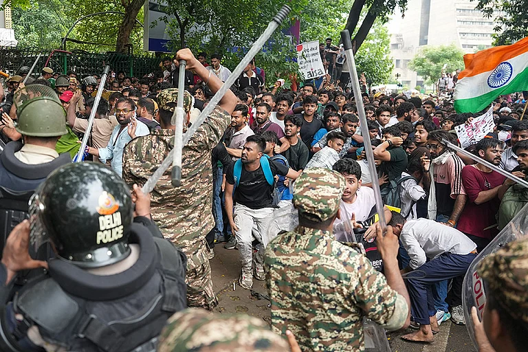 Police personnel stop Cockroach Janata Party (CJP) supporters during a protest march, near the Jantar Mantar, at Sansad Marg, in New Delhi. - | Photo: PTI/Karma Bhutia