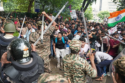 Police personnel stop Cockroach Janata Party (CJP) supporters during a protest march, near the Jantar Mantar, at Sansad Marg, in New Delhi. Delhi Police is on high alert ahead of the Monsoon Session of Parliament and CJP's proposed "Chalo Sansad" march on Monday.