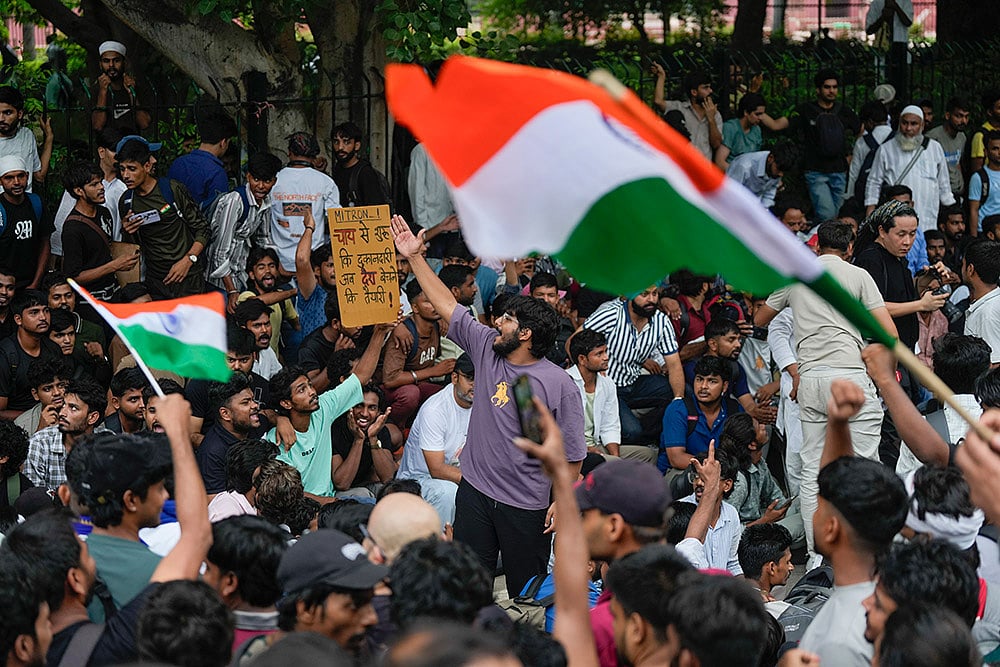 Cockroach Janata Party (CJP) supporters raise slogans as they gather ahead of a protest march, at the Jantar Mantar, in New Delhi, early Monday, July 20, 2026. Delhi Police is on high alert ahead of the Monsoon Session of Parliament and CJP's proposed "Chalo Sansad" march on Monday, with heavy deployment of personnel visible at every nook and corner around Jantar Mantar, Parliament and other key locations. - Photo: PTI/Salman Ali