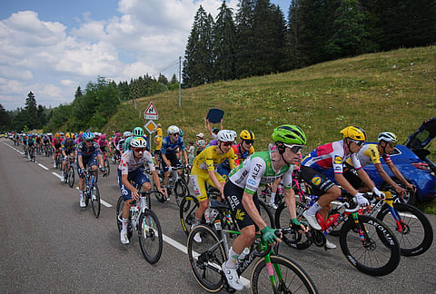 Slovenia's Tadej Pogacar, wearing the overall leader's yellow jersey, rides with the pack during the fifteenth stage of the Tour de France cycling race, from Champagnole to Plateau de Solaison, France, Sunday, July 19, 2026.
