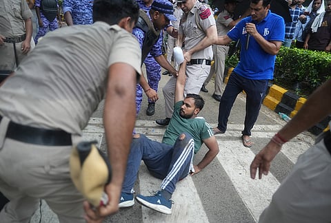 Police and security personnel remove Cockroach Janata Party (CJP) supporters ahead of a protest march, near the Jantar Mantar at Sansad Marg, in New Delhi, Monday, July 20, 2026. 