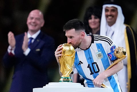 Argentina's Lionel Messi kisses the World Cup trophy after receiving the Golden Ball award for best player of the tournament during the awards ceremony after Argentina defeated France at the World Cup final in Lusail, Qatar, Dec. 18, 2022. 