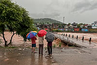 | Photo: PTI : People watch the swollen Mendhar river flowing above the danger level following heavy rains, in Mendhar, Poonch district, Jammu and Kashmir, Monday, July 20, 2026. 