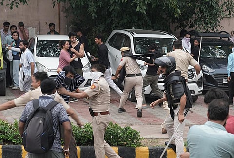 Security personnel stop Cockroach Janata Party (CJP) supporters as they raise slogans during a protest march, at Sansad Marg, in New Delhi, Monday, July 20, 2026.