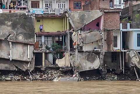 Houses are seen damaged in the aftermath of torrential rain-triggered landslides and flash floods, in Rajouri district, Jammu and Kashmir, Sunday, July 19, 2026. 