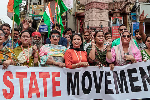Jammu State Movement workers stage a protest demanding the restoration of statehood to Jammu and Kashmir, in Jammu.