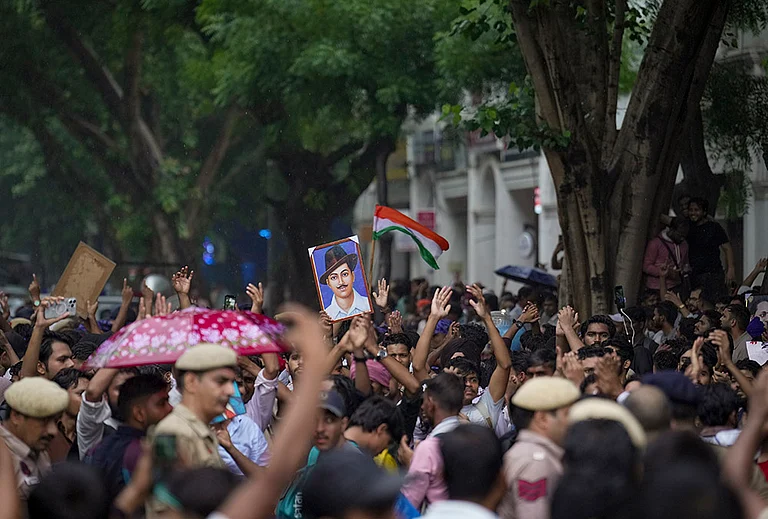 Cockroach Janata Party (CJP) supporters raise slogans, near Jantar Mantar ahead of a protest march, in New Delhi, early Monday, July 20, 2026. Delhi Police is on high alert ahead of the Monsoon Session of Parliament and CJP's proposed "Chalo Sansad" march on Monday, with heavy deployment of personnel visible at every nook and corner around Jantar Mantar, Parliament and other key locations. - | Photo: PTI/Karma Bhutia