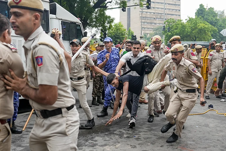 Security personnel detain Cockroach Janata Party (CJP) supporters as they raise slogans near Jantar Mantar during a protest march, in New Delhi, Monday, July 20, 2026. Delhi Police is on high alert ahead of the Monsoon Session of Parliament and CJP's proposed "Chalo Sansad" march on Monday, with heavy deployment of personnel visible at every nook and corner around Jantar Mantar, Parliament and other key locations. - PTI/KARMA