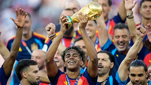 (AP Photo/Ashley Landis) : Spains Lamine Yamal celebrates with the trophy after winning the World Cup final soccer match between Spain and Argentina in East Rutherford, N.J., near New York, Sunday, July 19, 2026.