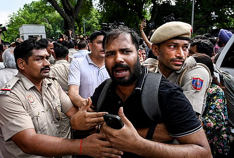 Police personnel try to evict Congress workers during a sit-in protest near the Prime Minister's residence over alleged irregularities in the NEET examination, in New Delhi, Tuesday, July 21, 2026. 
