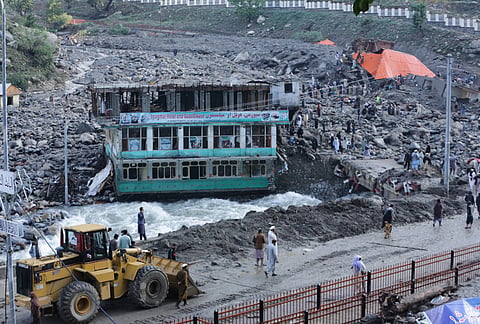Residents and rescue workers inspect buildings damaged by heavy flooding in the eastern province of Nuristan, Afghanistan, Tuesday, July 21, 2026. 