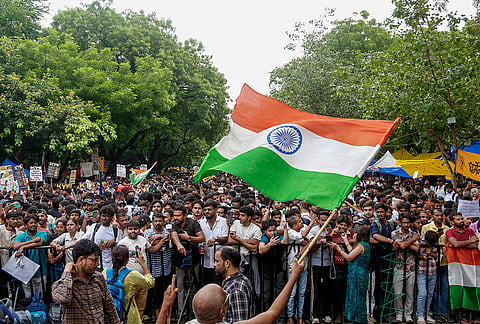 Cockroach Janata Party (CJP) supporters gather during a protest demanding the resignation of Union Education Minister Dharmendra Pradhan over alleged irregularities in the NEET examination, in New Delhi, Tuesday, July 21, 2026. 