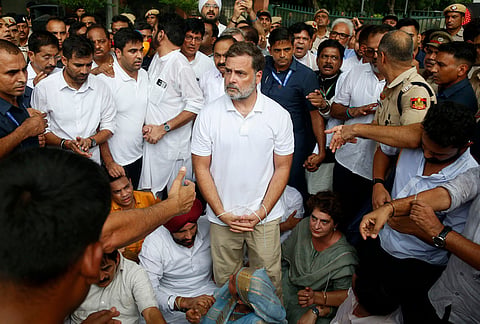 Congress party leader Rahul Gandhi, center, with his hands tied, participates in a sit-in protest with his sister and lawmaker Priyanka Gandhi Vadra, center right, outside the residence of Prime Minister Narendra Modi in New Delhi, Tuesday, July 21, 2026. 