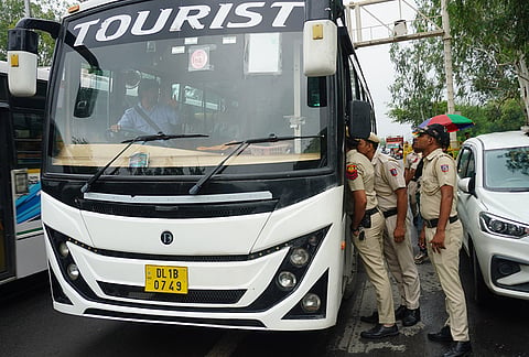 Police personnel inspect a vehicle ahead of a rally by farmers against the proposed India-US trade deal, near Millennium Park, in New Delhi, Tuesday, July 21, 2026. Farmers from several places in Punjab will take part in a rally to be held against the proposed India-US trade deal at Kisan Ghat. 