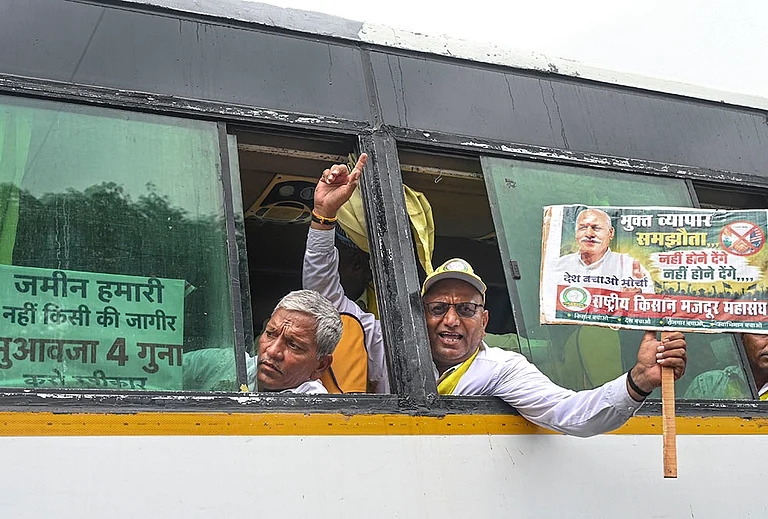 Farmers under the banner of 'Desh Bachao Morcha' hold placards as they arrive to take part in a rally to be held against the proposed India-US trade deal, at Kisan Ghat, in New Delhi, Tuesday, July 21, 2026. - | Photo: PTI