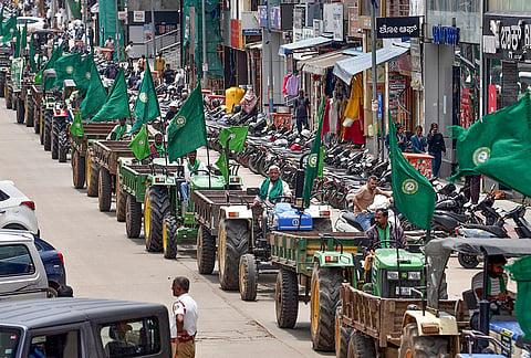 Farmers take out a tractor rally during the observance of Raitha Shaheed Dinacharane (Farmer Martyrs' Day), while protesting over various demands, in Chikkamagaluru, Karnataka.