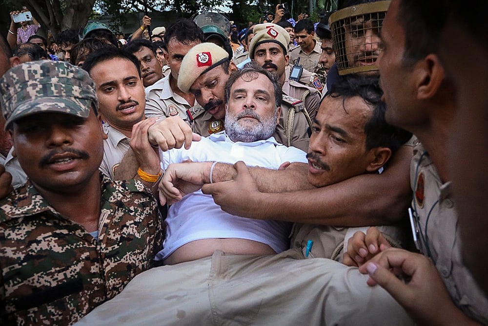 | Photo: @INCIndia via PTI  : In this image posted on July 21, 2026, Security personnel detain Leader of Opposition in the Lok Sabha Rahul Gandhi during a sit-in protest near the Prime Minister's residence over alleged irregularities in the NEET examination, in New Delhi.
