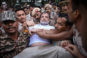 | Photo: @INCIndia via PTI : In this image posted on July 21, 2026, Security personnel detain Leader of Opposition in the Lok Sabha Rahul Gandhi during a sit-in protest near the Prime Minister's residence over alleged irregularities in the NEET examination, in New Delhi.