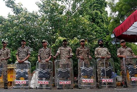 Security officers stand guard at the camping site of the Cockroach Janta Party at Jantar Mantar in New Delhi, Tuesday, July 21, 2026. 