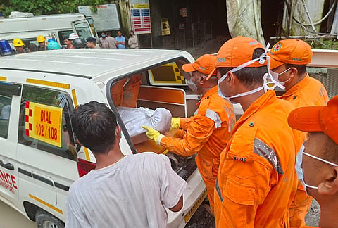 Rescue workers carry the body of a victim into an ambulance outside the entrance to an under-construction tunnel at a hydropower project in Samardung village, about 40 kilometers (25 miles) from Gangtok, Tuesday, July 21, 2026. 