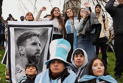 Argentina fans hold a photo of Lionel Messi as they gather outside the Argentine Football Association headquarters and wait for the national team to arrive in Ezeiza, on the outskirts of Buenos Aires, Monday, July 20, 2026, following its World Cup final loss to Spain. 