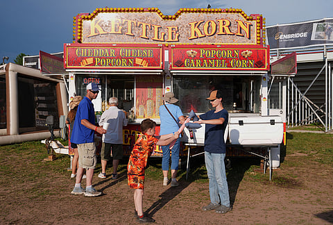Children play with blow-up axes while waiting in line for concessions during the Lumberjack World Championships, Friday, July 17, 2026, in Hayward, Wisconsin. 