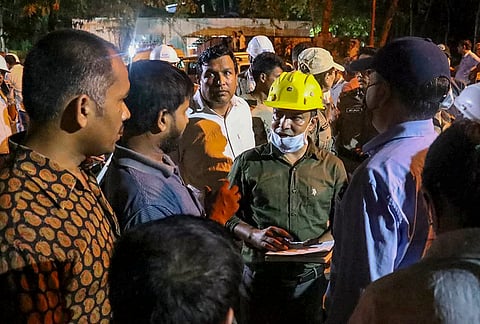 People gather after about 27 workers were trapped inside an under-construction tunnel after a landslide blocked its entrance and triggered a suspected gas leak, in Namchi district, Sikkim. 