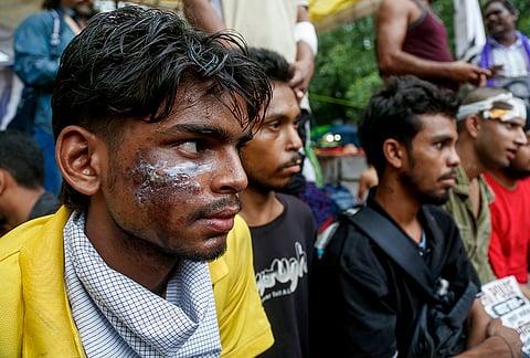 Cockroach Janata Party (CJP) supporters gather during a protest demanding the resignation of Union Education Minister Dharmendra Pradhan over alleged irregularities in the NEET examination, in New Delhi, Tuesday, July 21, 2026. 