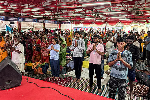Stranded pilgrims perform yoga at a base camp after the authorities temporarily suspended the Amarnath Yatra due to inclement weather, in Jammu.