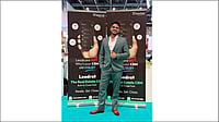 Himanshu Kumar standing in front of the Leadrat real estate CRM exhibition banners