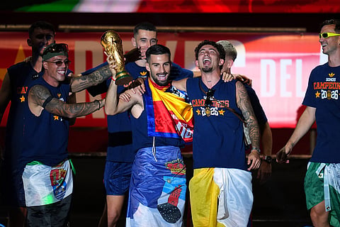 Spain's Alex Baena holds the trophy during celebrations with his national team teammates at Cibeles Square in Madrid on Monday, July 20, 2026, after Spain defeated Argentina in the World Cup final in East Rutherford, N.J., near New York.