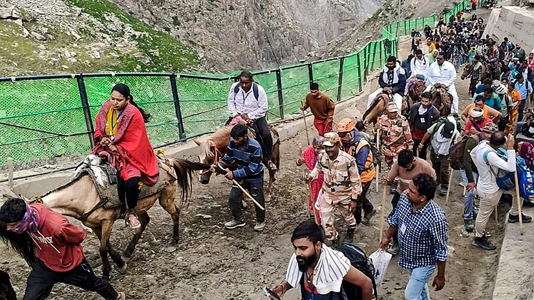 Pilgrims proceed towards the holy cave shrine of Amarnath during the ongoing 'Amarnath Yatra', in Jammu. - | Photo: PTI