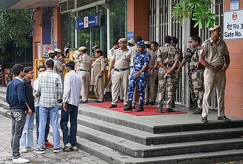 Rapid Action Force (RAF) and Police personnel stand guard outside Patel Chowk Metro station after it was closed due to 'security reasons', in New Delhi.