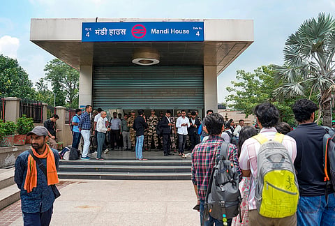 Commuters gather outside gate no. 4 of the Mandi House metro station as it is being closed due to security reasons, in New Delhi. Sixteen Delhi Metro stations, including Rajiv Chowk, Central Secretariat, Mandi House, ITO and Khan Market, were closed amid the ongoing Cockroach Janta Party (CJP) protest at Jantar Mantar. 