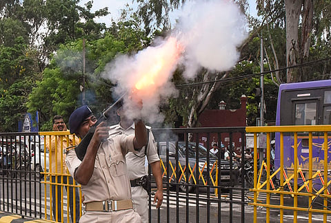 Police personnel use tear gas shells to disperse All India Students' Association (AISA) activists during a 'Lok Bhavan March' over alleged NEET paper leak, in Patna, Bihar.