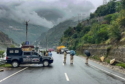 Police personnel block traffic on the Batote-Kishtwar National Highway after heavy rain and continuous shooting stones forced its closure at vulnerable locations, in Doda district, Jammu and Kashmir. The highway was closed as a precautionary measure, and authorities advised commuters to avoid unnecessary travel until weather conditions improve. 