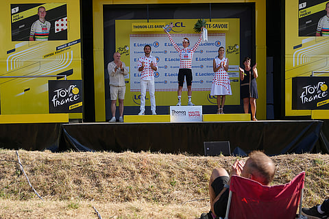 Slovenia's Tadej Pogacar, wearing the best climber's dotted jersey, celebrates on the podium after the sixteenth stage of the Tour de France cycling race, an indivdual time-trial with start in Evian-Les-Bains and finish in Thonon-les-Bains, France.