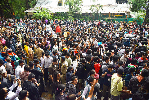 People stage a protest in support of Cockroach Janta Party (CJP) and demanding the resignation of Union Education Minister Dharmendra Pradhan over alleged irregularities in the NEET examination, at Shivaji Park in Mumbai, Tuesday, July 21, 2026.