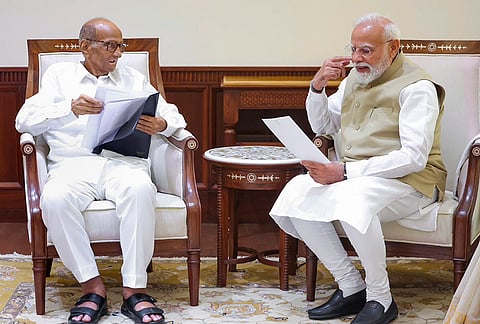 Prime Minister Narendra Modi interacts with NCP (SP) President Sharad Pawar during a meeting, at Parliament House, in New Delhi. 
