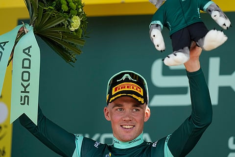 Denmark's Mads Pedersen, wearing the best sprinter's green jersey, celebrates on the podium after the sixteenth stage of the Tour de France cycling race, an indivdual time-trial with start in Evian-Les-Bains and finish in Thonon-les-Bains, France.