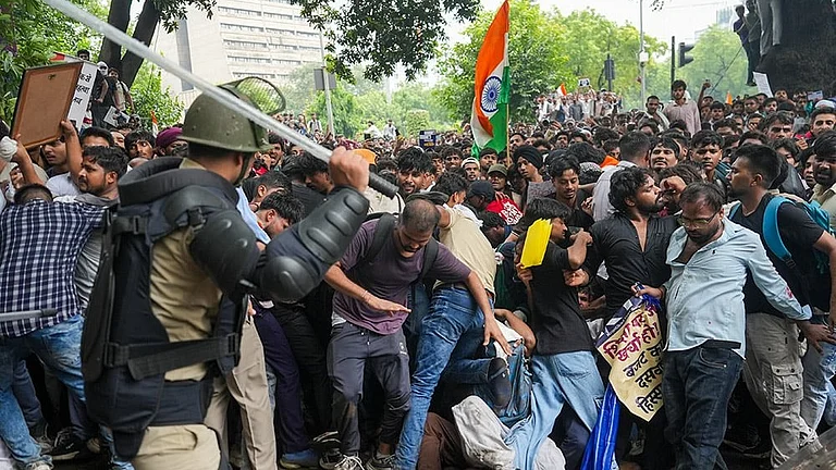 Security personnel stop Cockroach Janata Party (CJP) supporters as they raise slogans near Jantar Mantar during a protest march, in New Delhi. - Photo: PTI/Karma Bhutia