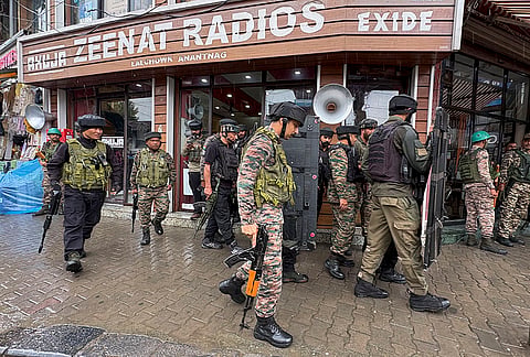 Security personnel conduct a search operation following a terrorist attack in which a police head constable was killed, in Anantnag, Jammu and Kashmir.