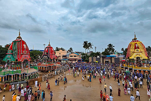 Servitors and police personnel pull the chariots of Lord Jagannath and Lord Balabhadra during the 'Dakshina Moda' ritual from the Gundicha Temple to Nakachana Dwara, in Puri, Odisha.