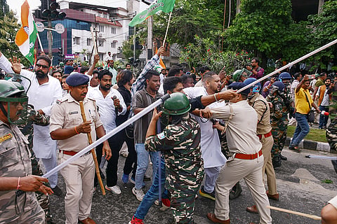 Police officials at the site after Congress and BJP workers allegedly hurled stones and eggs at each other during a protest march led by the former party workers towards the BJP headquarters against the NEET paper leak issue, in Ranchi.