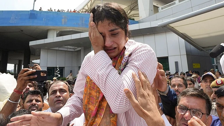 Wrestling Federation of India (WFI) issues a show-cause notice to wrestler Vinesh Phogat for alleged indiscipline and anti-doping rule violations, and barred her from domestic events till June 26th over non-compliance with UWW Anti-Doping Rules, in New Delhi. Vinesh Phogat gets emotional as she arrives after Paris Olympics heartbreak, at IGI airport, in New Delhi, in this file photo dated August 17, 2024. - | Photo: PTI/Ravi Choudhary