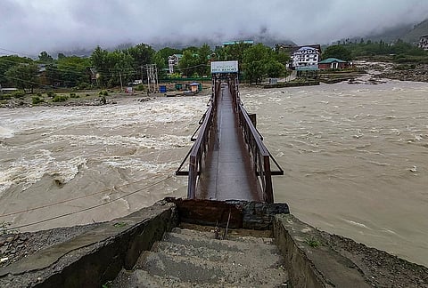 A damaged footbridge over the Lidder River following flash floods triggered by heavy rainfall, in Pahalgam, Anantnag district, Jammu and Kashmir.