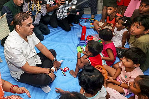 Assam Chief Minister Himanta Biswa Sarma interacts with children during a visit to a relief camp in a flood-affected area, in Golaghat district, Assam.
