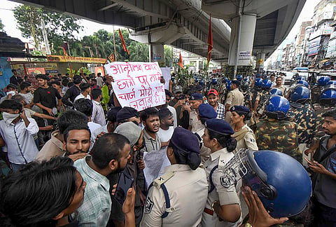 Police personnel stop protestors during a protest demanding the resignation of Union Education Minister Dharmendra Pradhan over the NEET paper leak issue, in Patna, Bihar, Thursday, July 23, 2026. 