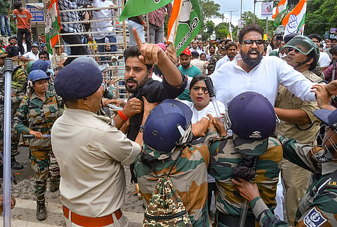 Security personnel intervene as Congress and BJP workers clash during a Congress protest outside the BJP state headquarters over the alleged NEET paper leak issue, in Ranchi.