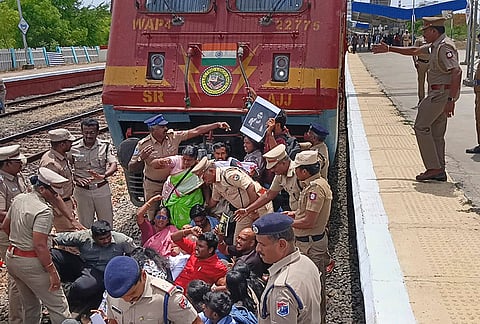 Police remove Students' Federation of India protestors blocking a railway track over the NEET exam issue, at Thiruparankundram railway station in Madurai, Thursday, July 23, 2026. 
